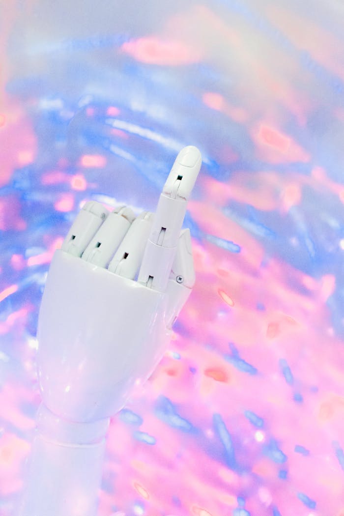 Close-up of a robotic hand against a colorful, futuristic background.